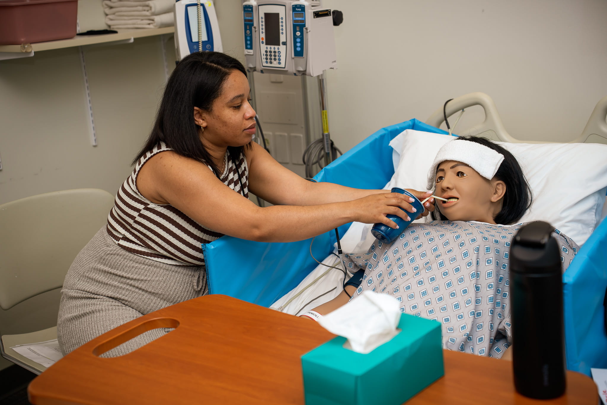 Woman practicing care on fake patient