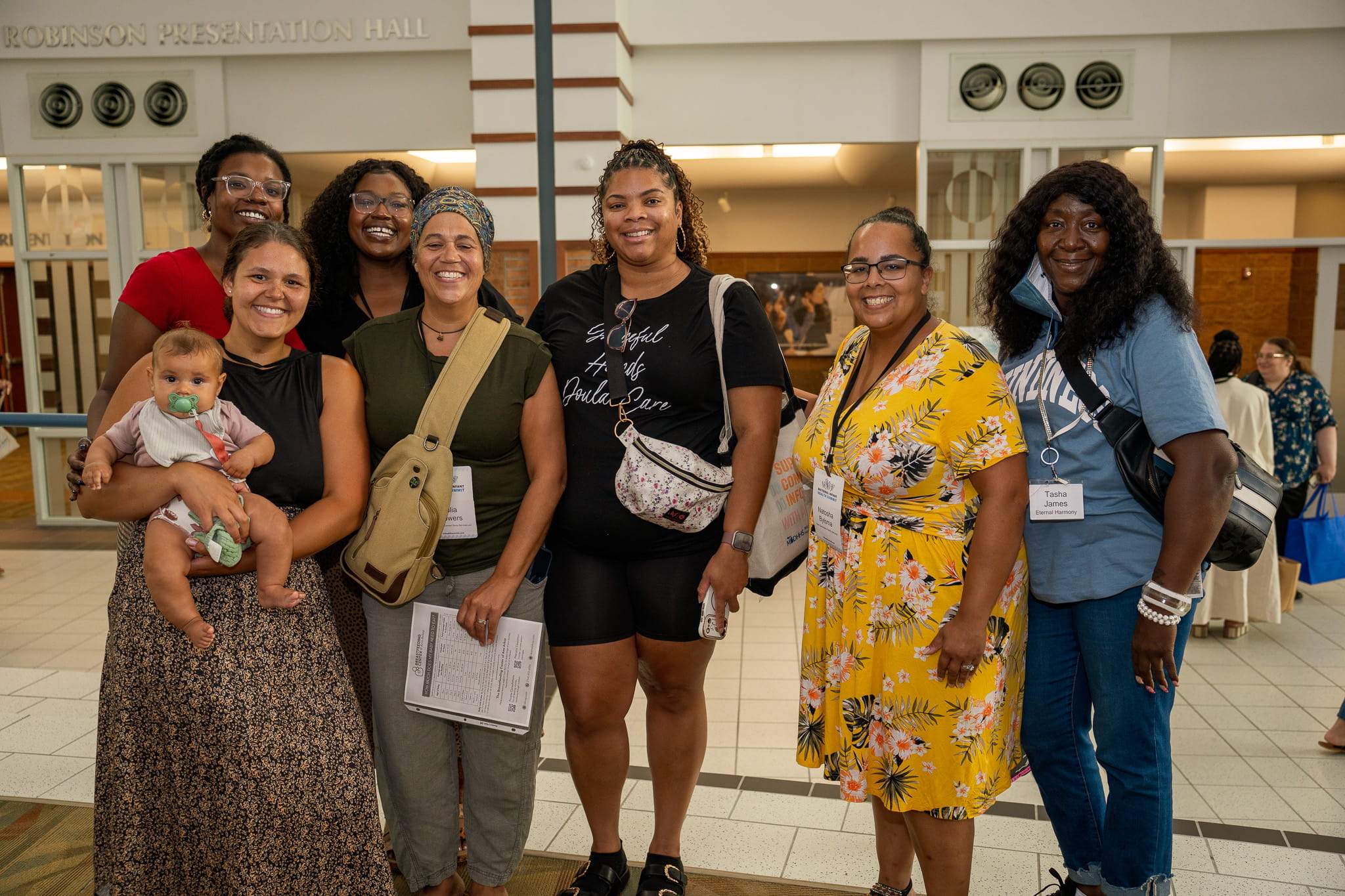 Group photo with 7 women and a baby