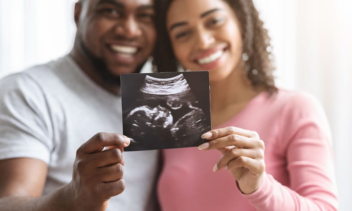 expectant parents holding a sonogram