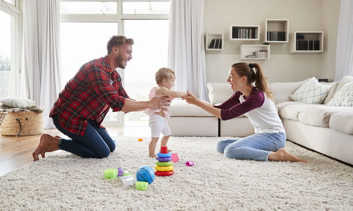toddler walking from father to mother