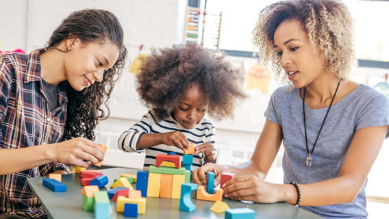 providers and child playing with blocks