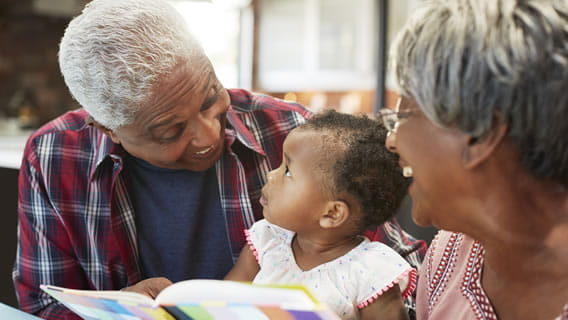grandparents reading to baby