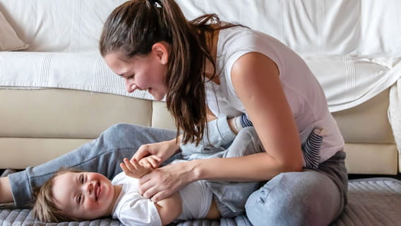 mom playing with child on the floor
