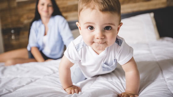 baby crawling away from mom