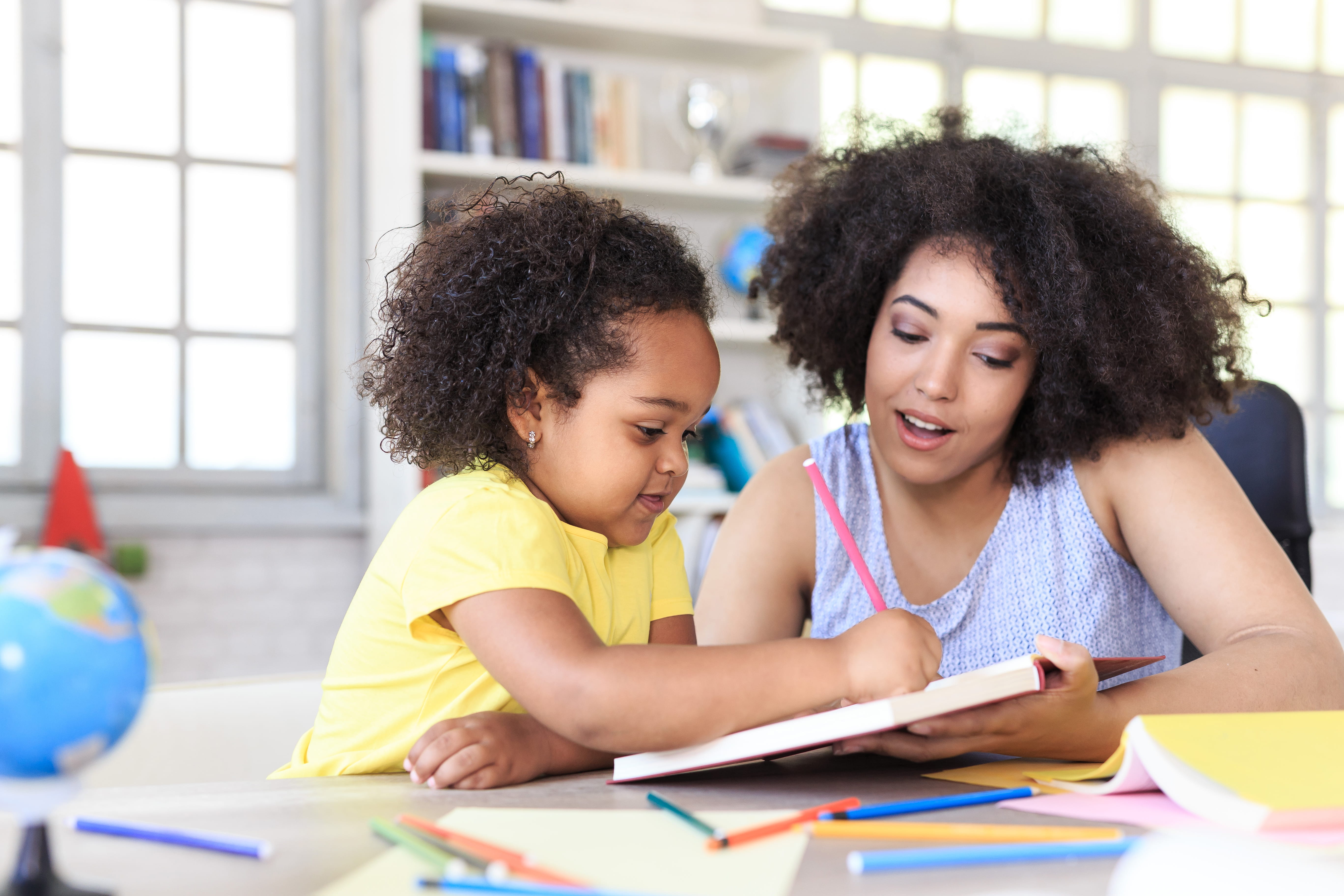 mom reading to daughter 