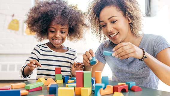 mom and daughter playing with blocks