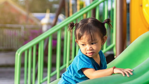 toddler playing on play place