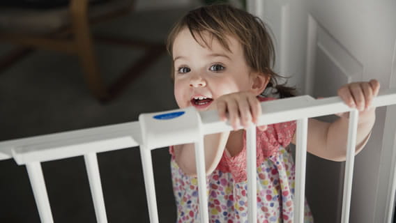 toddler looking over safety rail