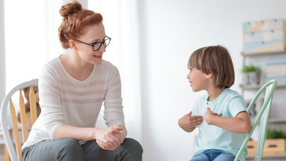 a child and provider sitting in chairs talking