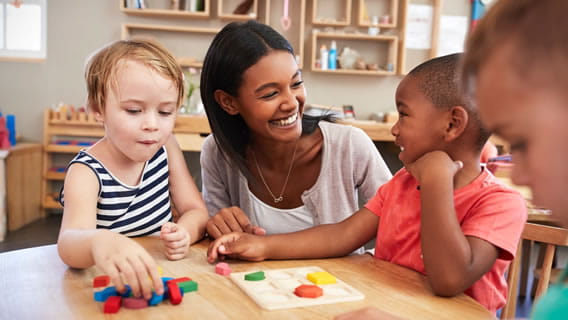 Two children and provider playing with shape toys