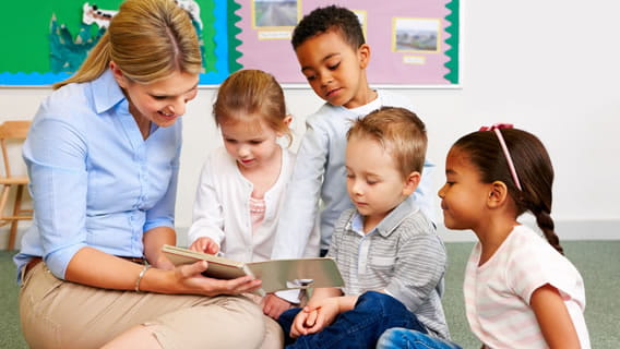Preschoolers reading with teacher