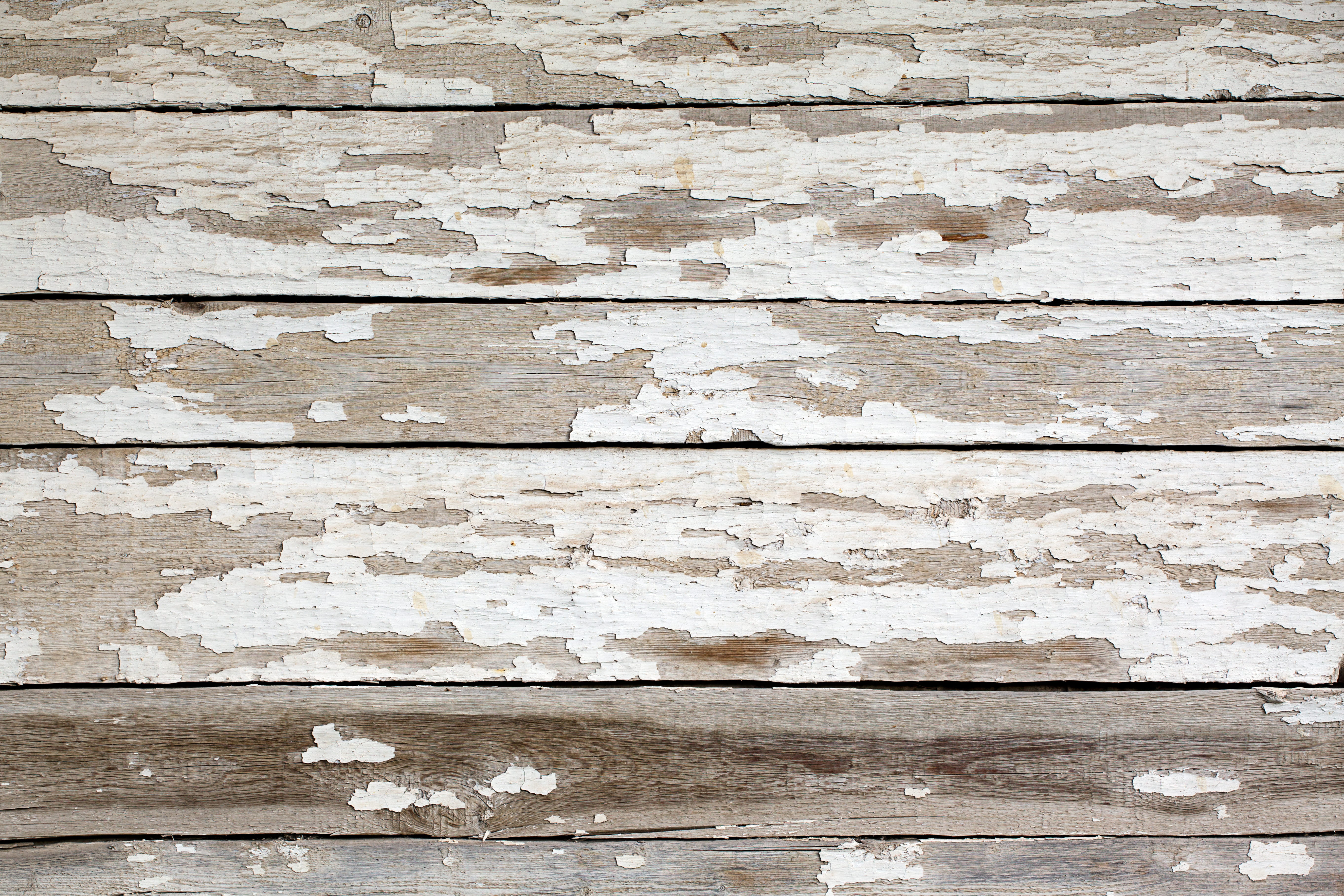 Exterior wood siding with white chipping paint