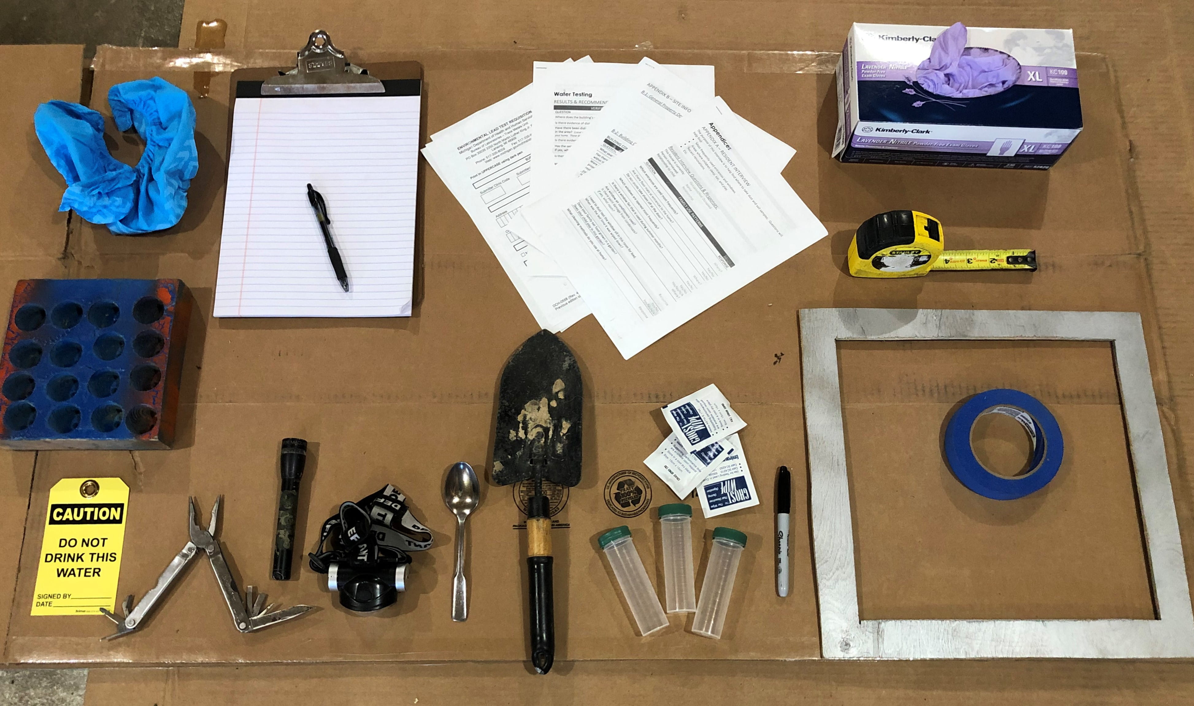 A variety of equipment displayed on a table required for a lead inspection
