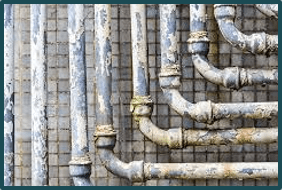 Several pipes in front of a tiled background
