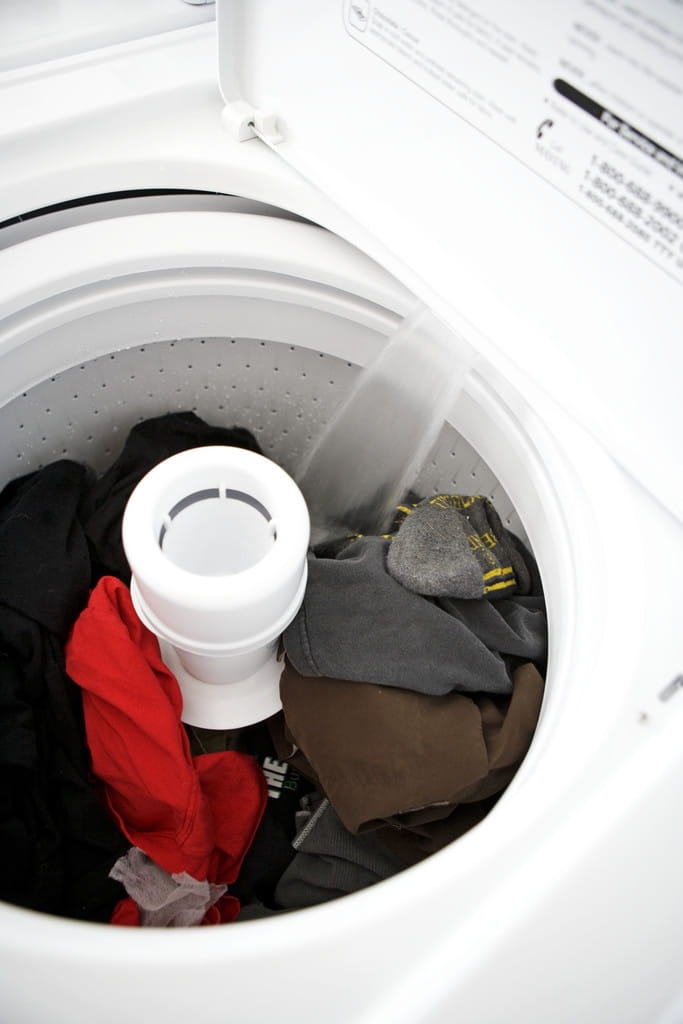 Open washing machine with dirty clothes