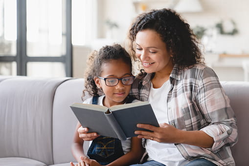 parent reading book to child 