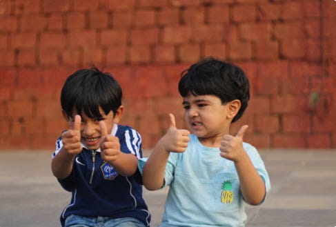 2 boys giving thumbs up