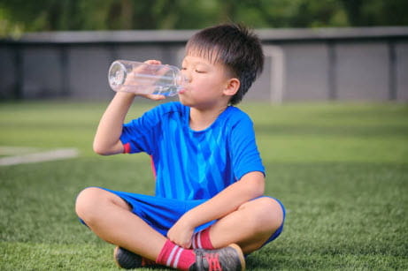 boy drinking from reusable bottle