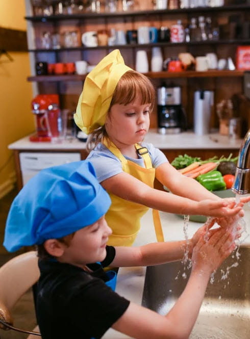 girl and boy washing hands