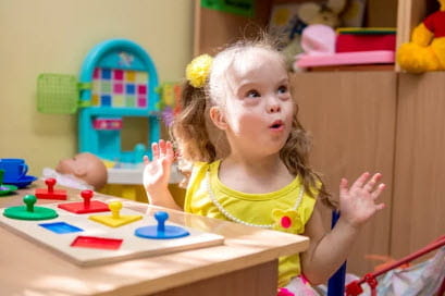 girl in yellow shirt doing puzzle
