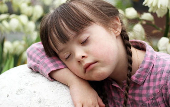 girl with braids and plaid shirt sleeping