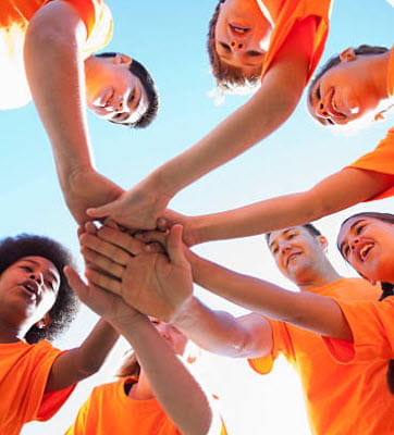 kids in a circle with hands in