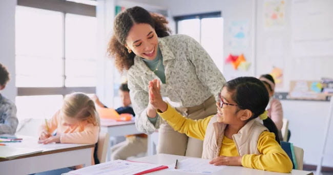 teacher high fiving student
