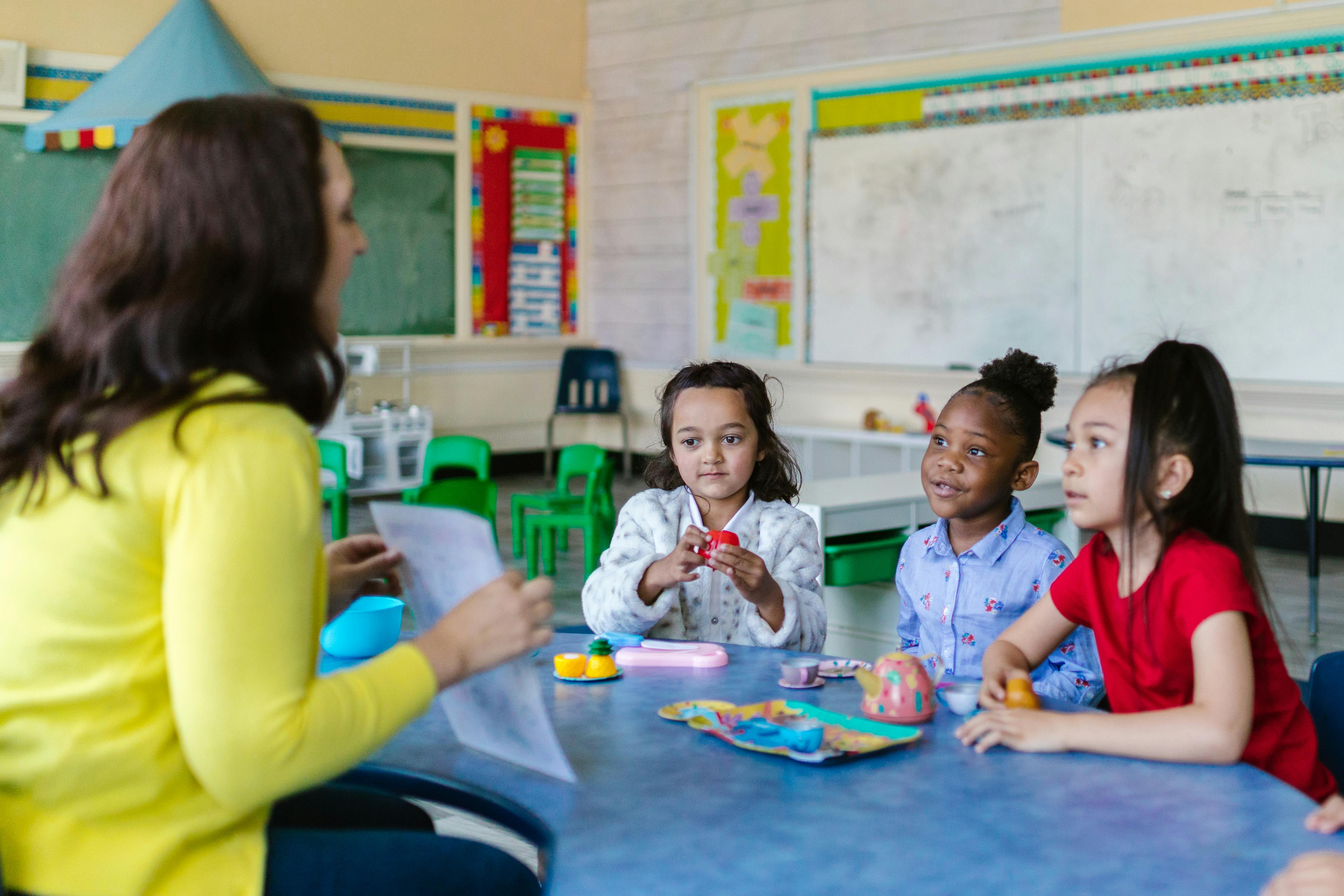 teacher with kids at a table