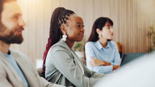 Woman seated at a table during a meeting