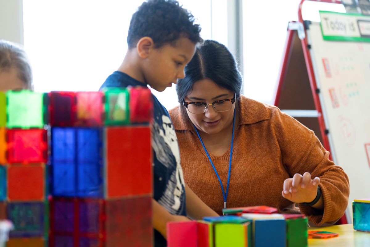 A teacher and student engaged in an activity together