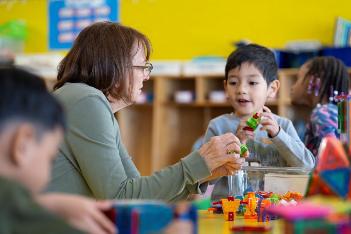 A teacher and student engaged in an activity in the classroom