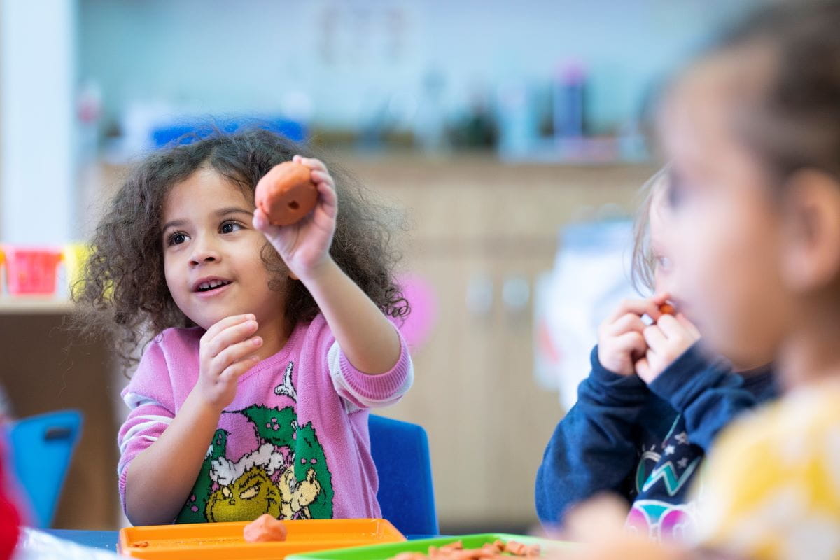 A close up of two young students seated at a table