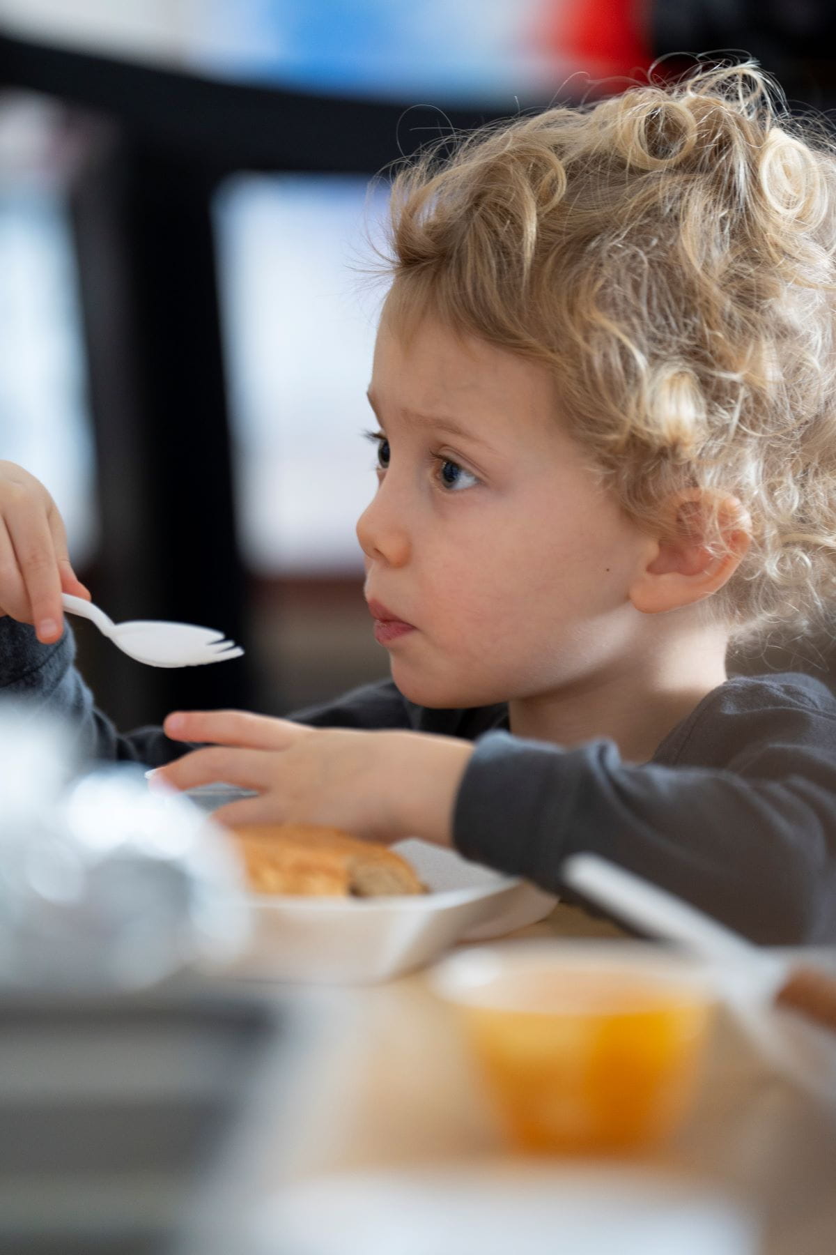 A close up of a young student eating a snack