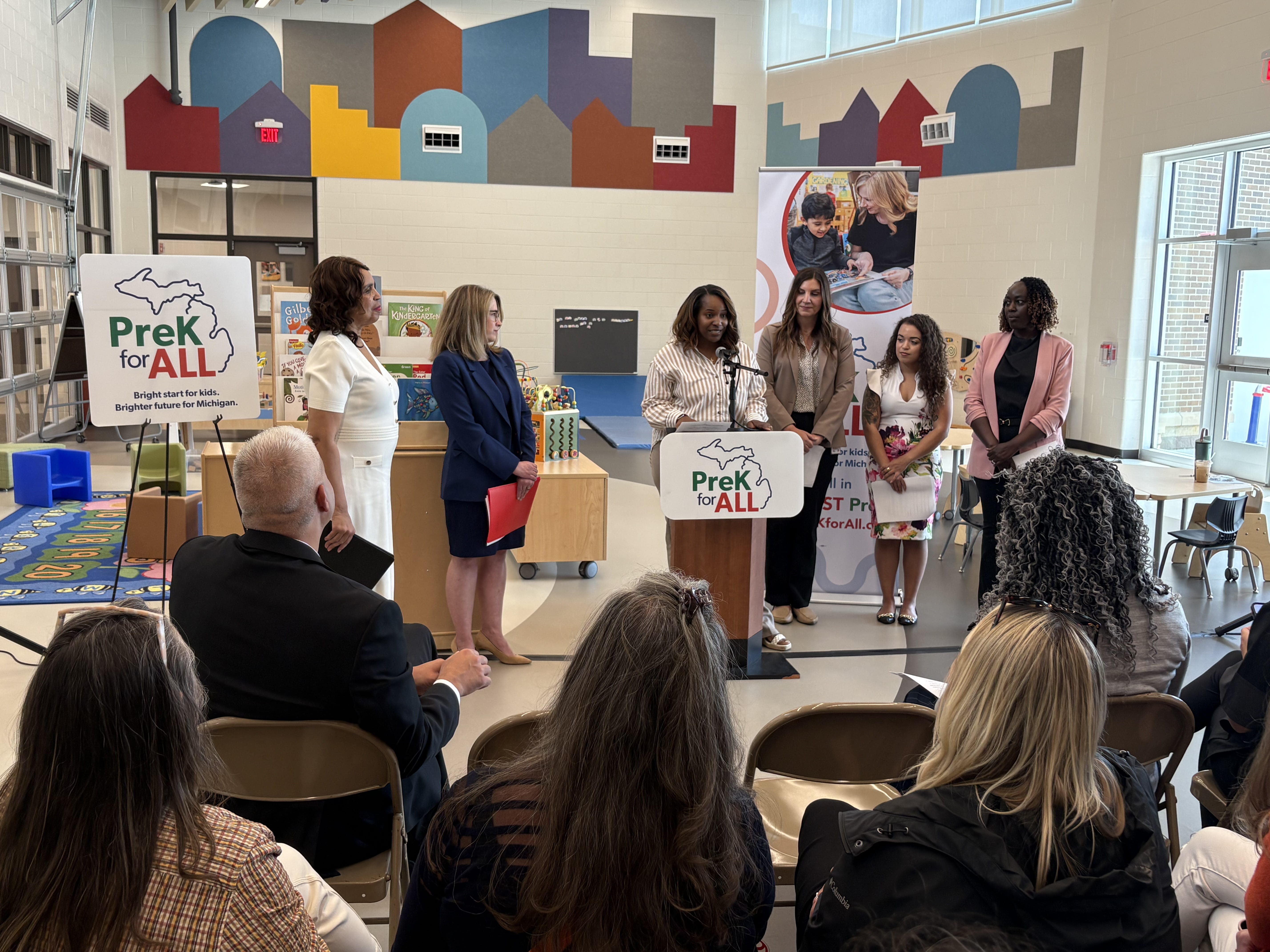 Crowd shot of Alanna LaMay stands at podium, speaking at PreK for All press event