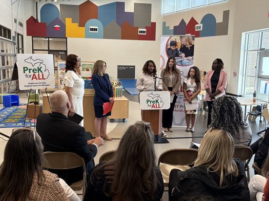 Crowd shot of Alanna LaMay stands at podium, speaking at PreK for All press event