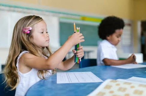 girl with pencils in hand