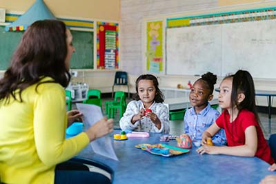 Teacher with kids at a table