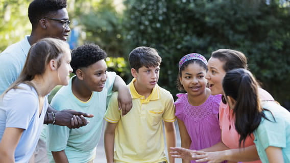 six school children outside with teacher getting instructions