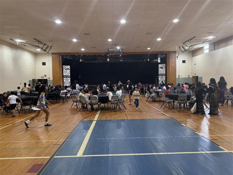 Parents, students and community members take their seats at The Burma Center for a celebration highlighting the THRIVE Summer Youth Program's achievements and impact in Battle Creek.