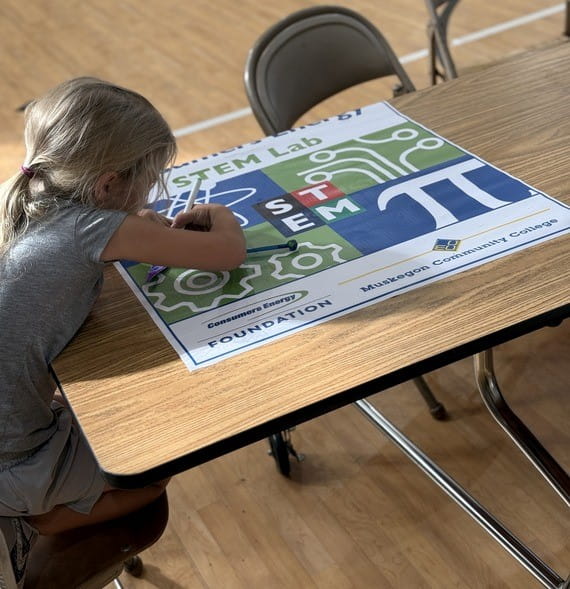 Student working on a STEM activity at a table