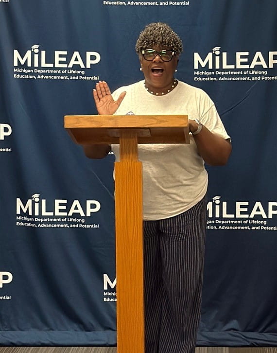 An adult speaking at a podium