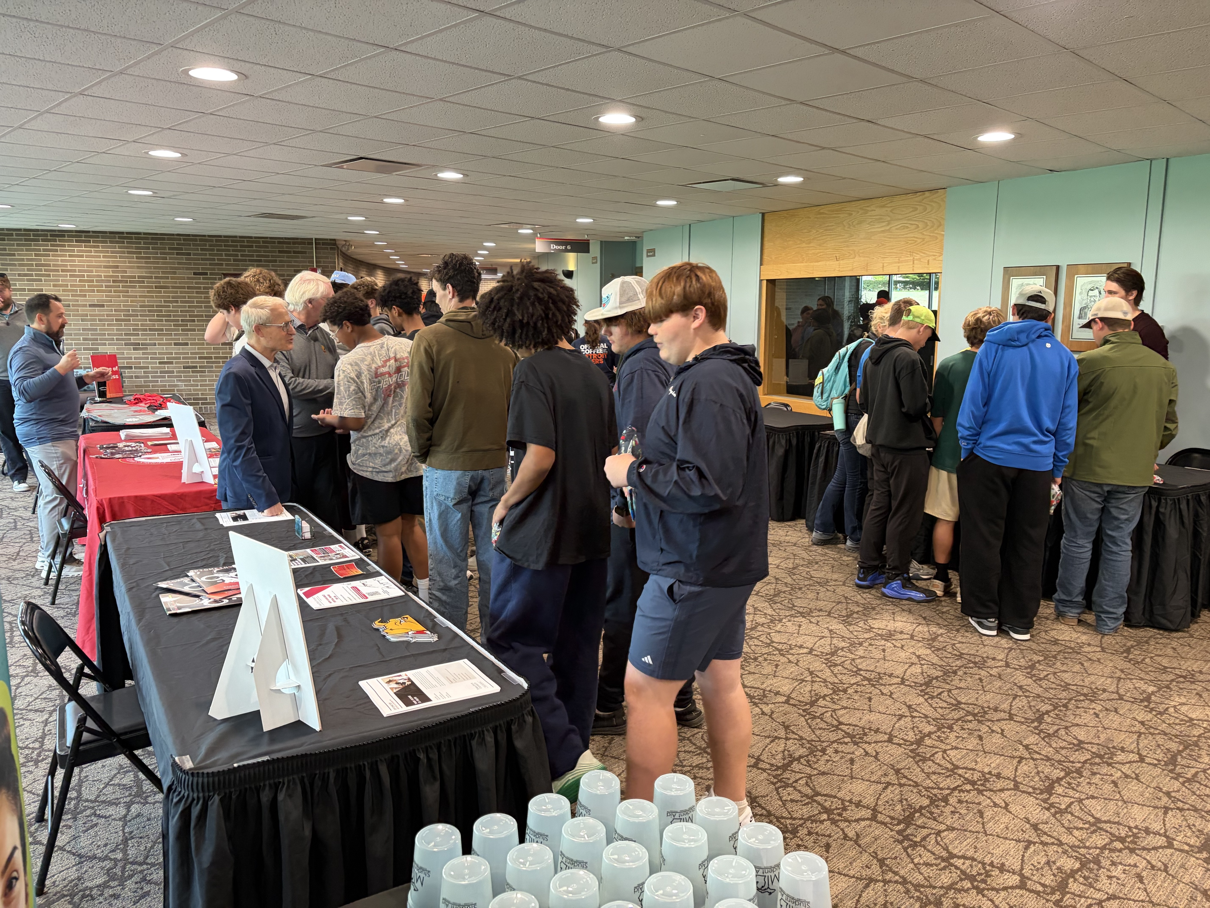 A group of students explore booths at the Ferris State University MiKickoff event