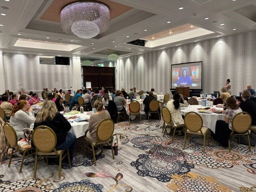 Early educators attend Literacy Day of Learning training in Grand Rapids, watching a recorded message from Governor Gretchen Whitmer.