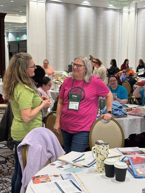 Two early educators discuss literacy strategies during Literacy Day of Learning training.