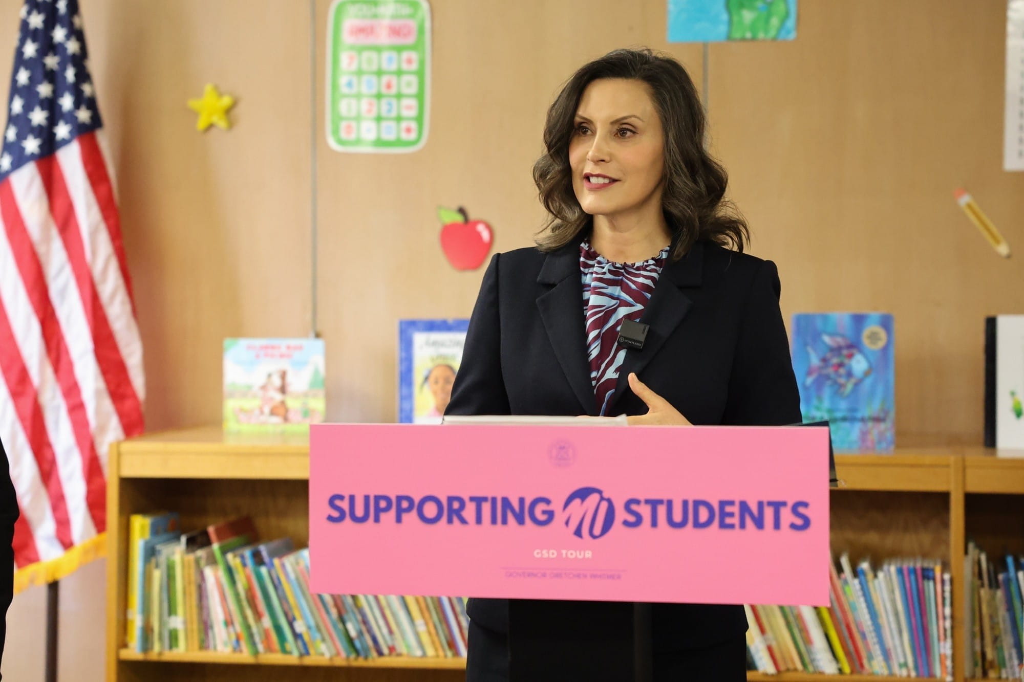 Gov. Whitmer stands at a podium and speaks to attendees at a PreK for All event