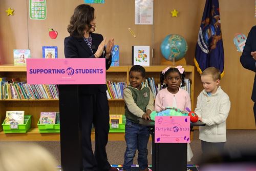 Governor Whitmer at PreK for All press event Gov. Whitmer claps while standing next to two preschool students at the PreK for All event