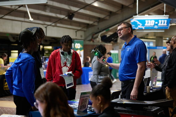Students stop by the Opportunity Hub to speak with a representative from the Northwestern Michigan College Aviation Division.