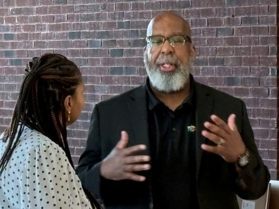 Jason Wilson, deputy director of MiLEAP’s Office of Strategic Talent Preparation, speaks with an attendee during the Men in Motion Summit at Eastern Michigan University on May 29, 2026.