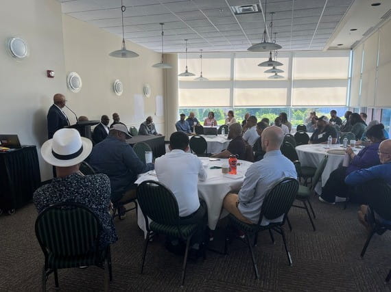 Attendees listen during a panel discussion at the Men in Motion Summit, which convened partners from across Michigan to discuss barriers and opportunities related to education, training, and workforce participation for men and boys.