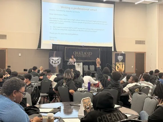 Students raise their hand to participate during a conversation designed to teach them about taking ownership of their next steps.
